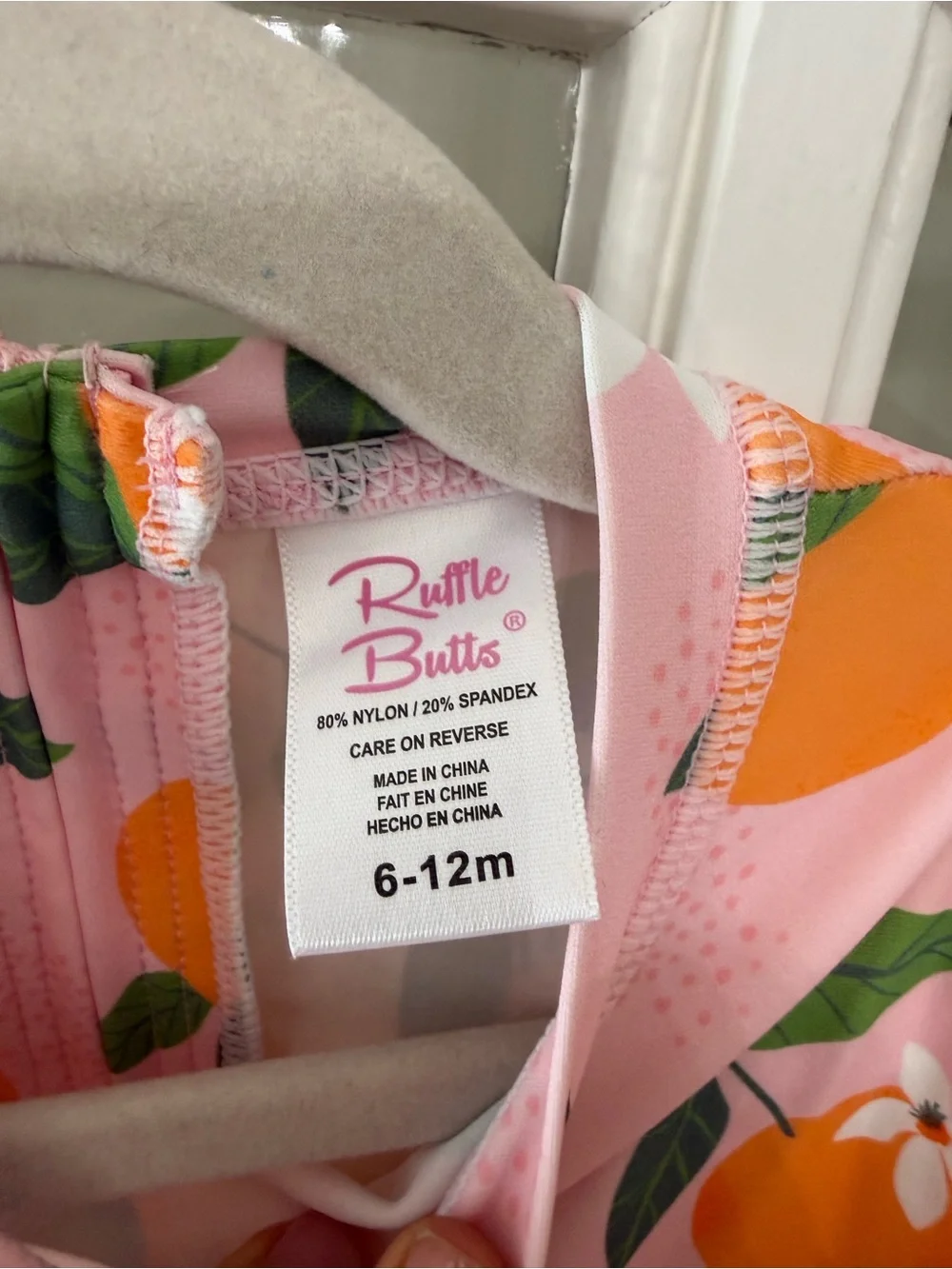 Ruffle Butts Pink Swimsuit with Orange Fruit Print